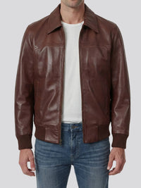 Brown leather jacket worn by a person on a white background